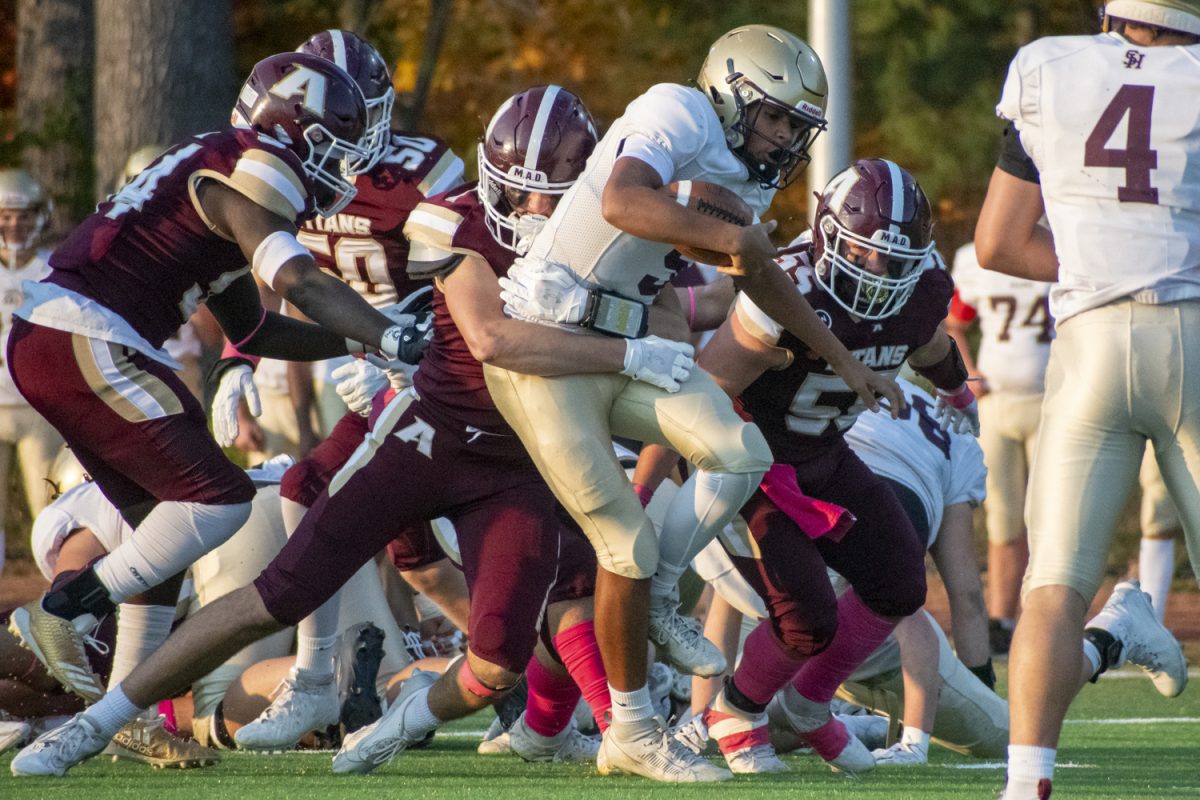 Senior Brendan Staunton pulls a Shepherd Hill opponent to the ground on Oct. 11 during Algonquin's 27-12 win.