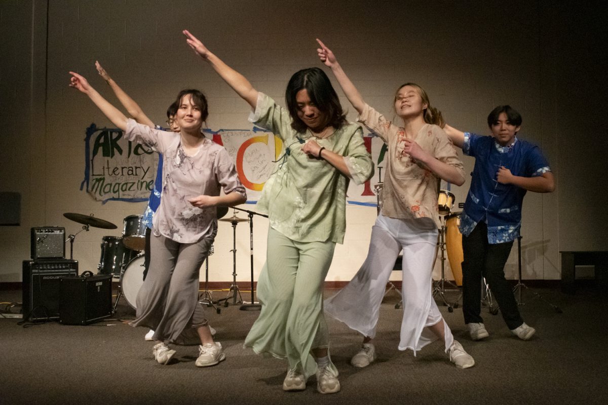 From left to right, seniors Terry Chang, Tanya Clemens, Caroline Lou, Sophia Wang and Alex Qi perform a dance at the end of the first set of Sachem's Haunted Coffeehouse on Oct. 17.