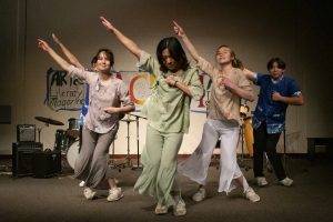 From left to right, seniors Terry Chang, Tanya Clemens, Caroline Lou, Sophia Wang and Alex Qi perform a dance at the end of the first set of Sachem's Haunted Coffeehouse on Oct. 17.
