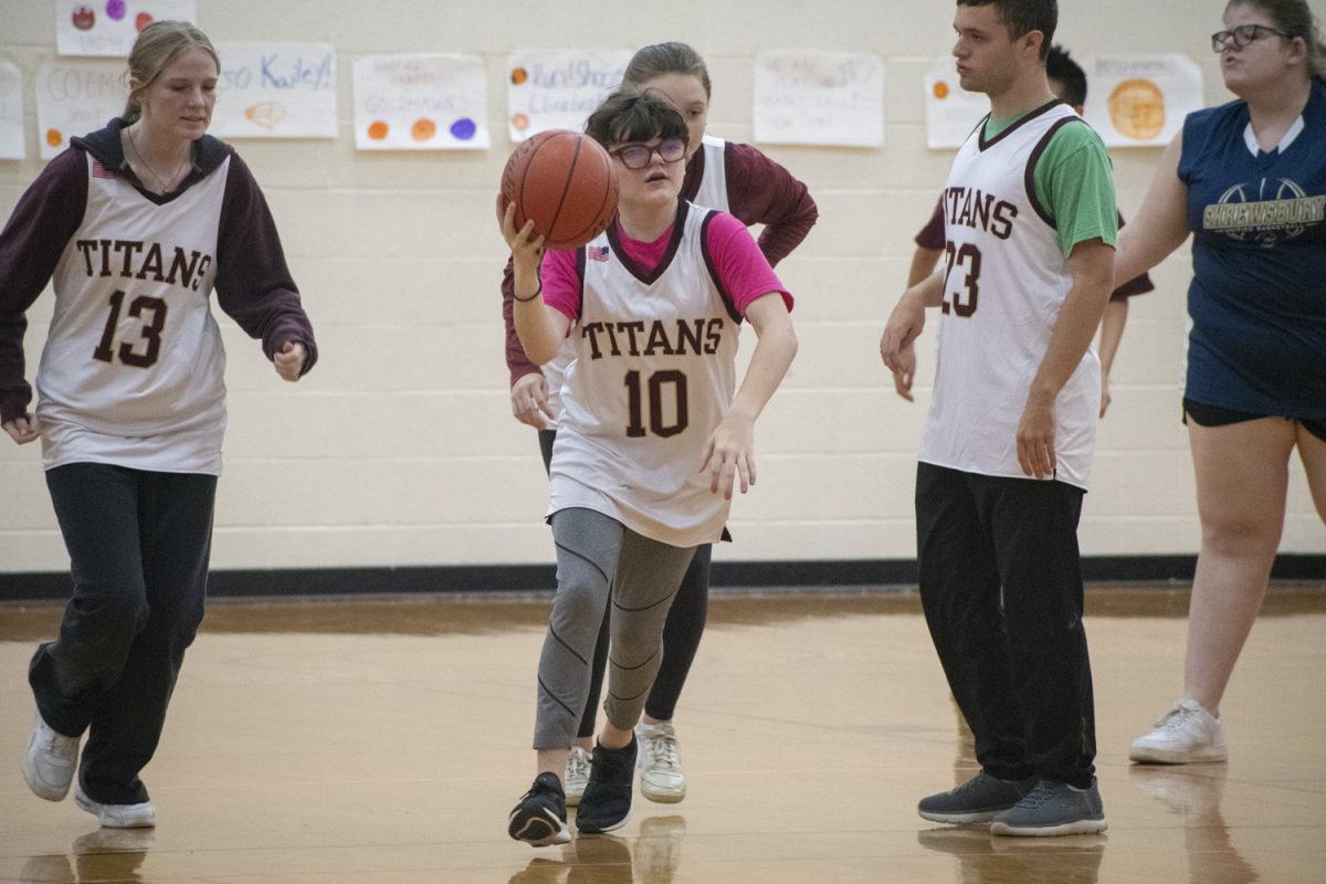 During their 46-42 win against Shrewsbury on Oct. 17, senior Catie Campbell (10) runs up the court with the basketball.