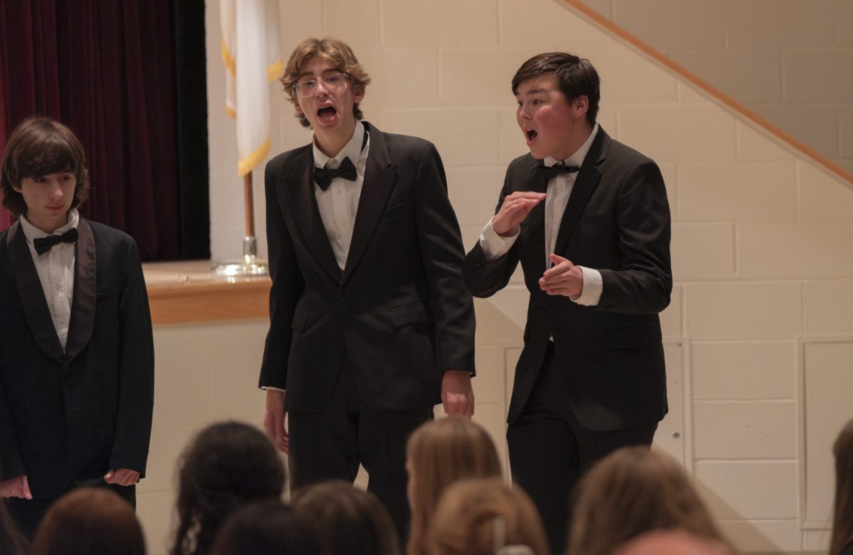 Senior Jax Jackson directs Algoncapella during the Oct. 22 Songs for the People choral concert.