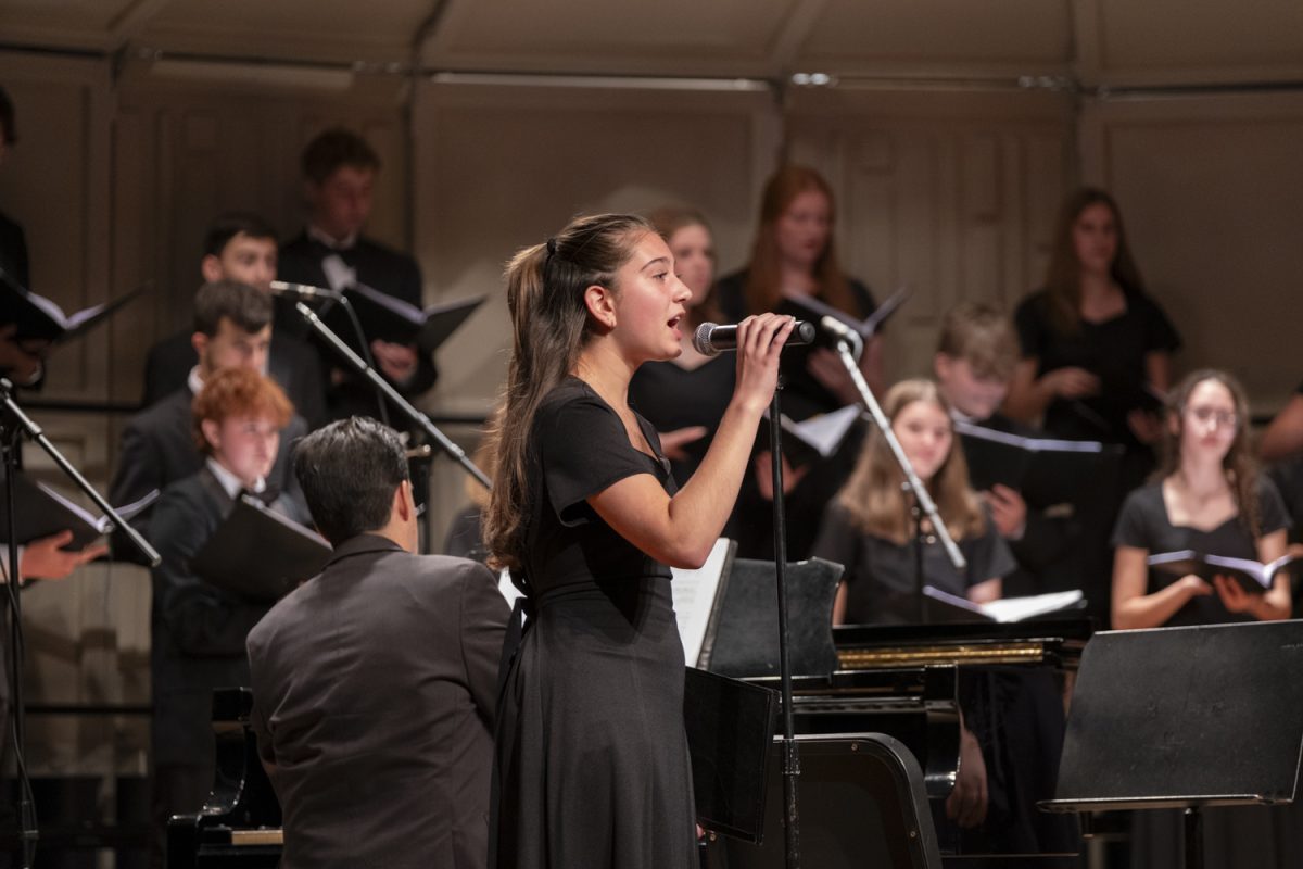 Freshman Sofia Benacchio sings a solo during “Songs for the People” by Jacob Narverud during the Songs for the People choral concert on Oct. 22.