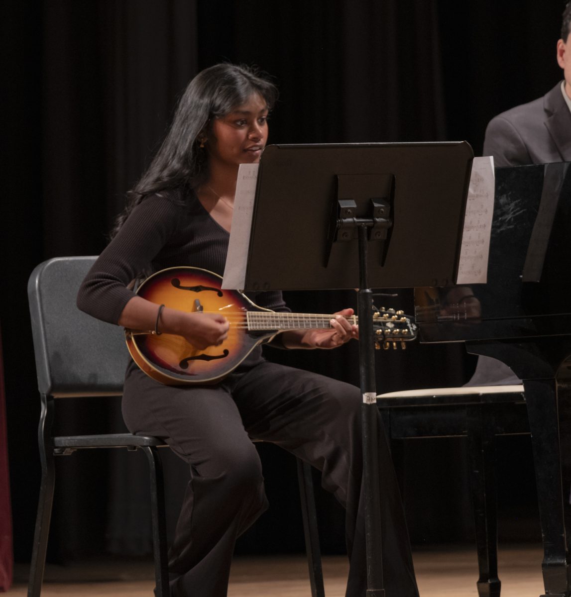 Senior Akshaya Pugazhendhi plays the mandolin for the song “Shady Grove,” an Appalachian folk tune, during the Songs for the People choral concert on Oct. 22.