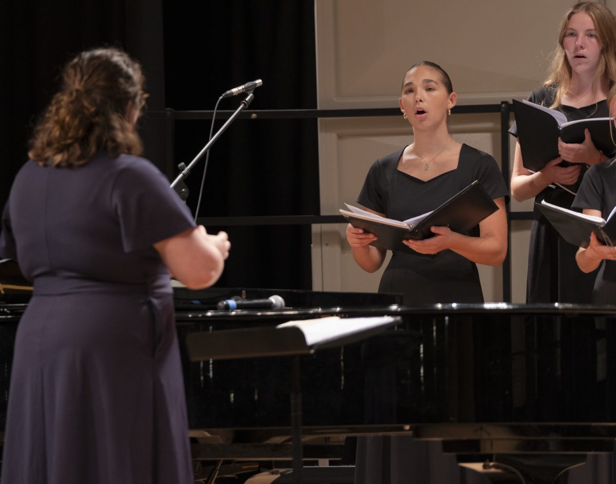 Junior Francis Edlemon sings during the Camarata Singers' performance of “i carry your heart with me(i carry it in)” at the Songs for the People choral concert on Oct. 22.