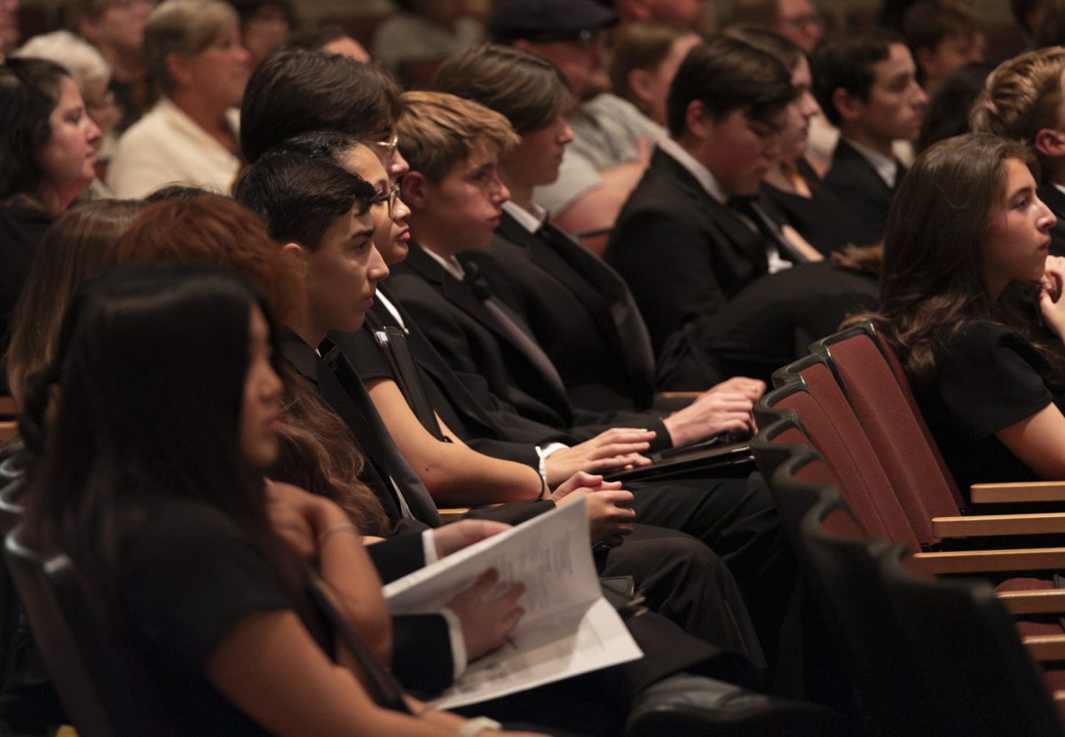 The members of the choirs watch during the Camerata Singers' performance of “Conker” by James Burton during the Songs for the People choral concert on Oct. 22.