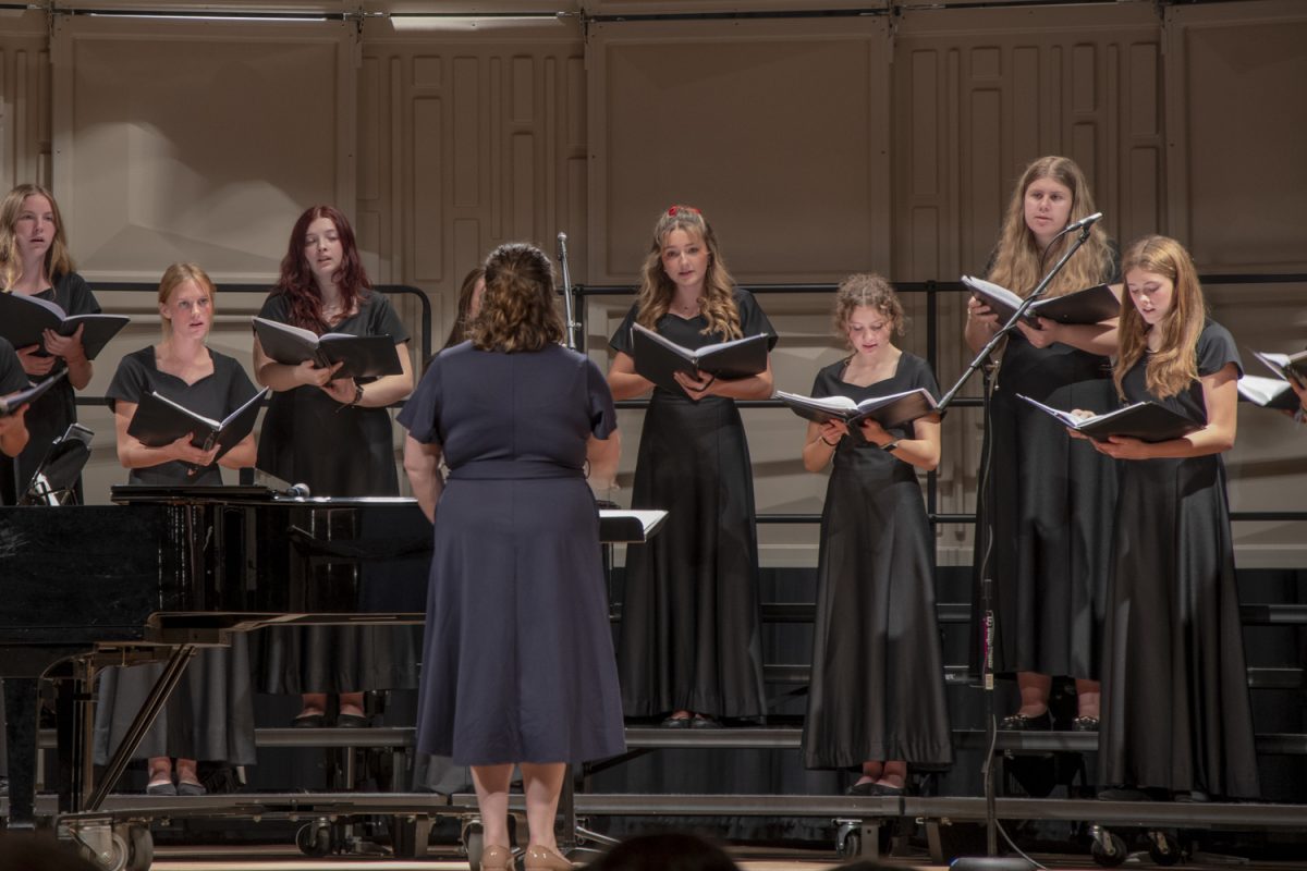 The Camerata Singers perform “i carry your heart with me (i carry in it),” as junior Ava Guckian (center) sings a solo. The Camerata Singers is one of two all-female groups, and sang 3 songs at the Fall Choral Concert on Oct. 22.