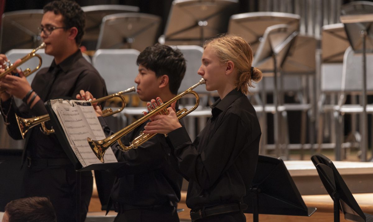 At the ARHS Fall Instrumental Concert on Oct. 30, freshmen Clark Bezzant, Devin Bajracharya and sophomore Matthew Beshay play “Aftershock” by Larry Barton on the trumpet.