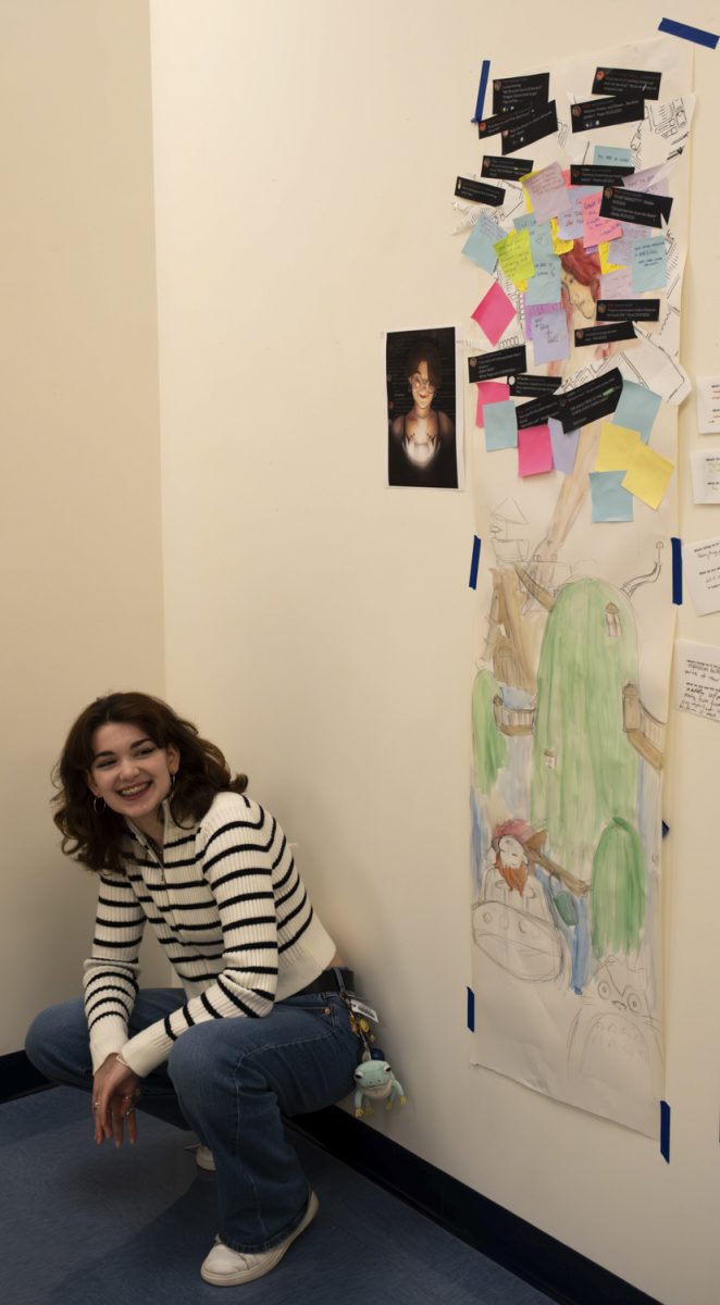 Junior Linden Schaffer poses with her artwork.