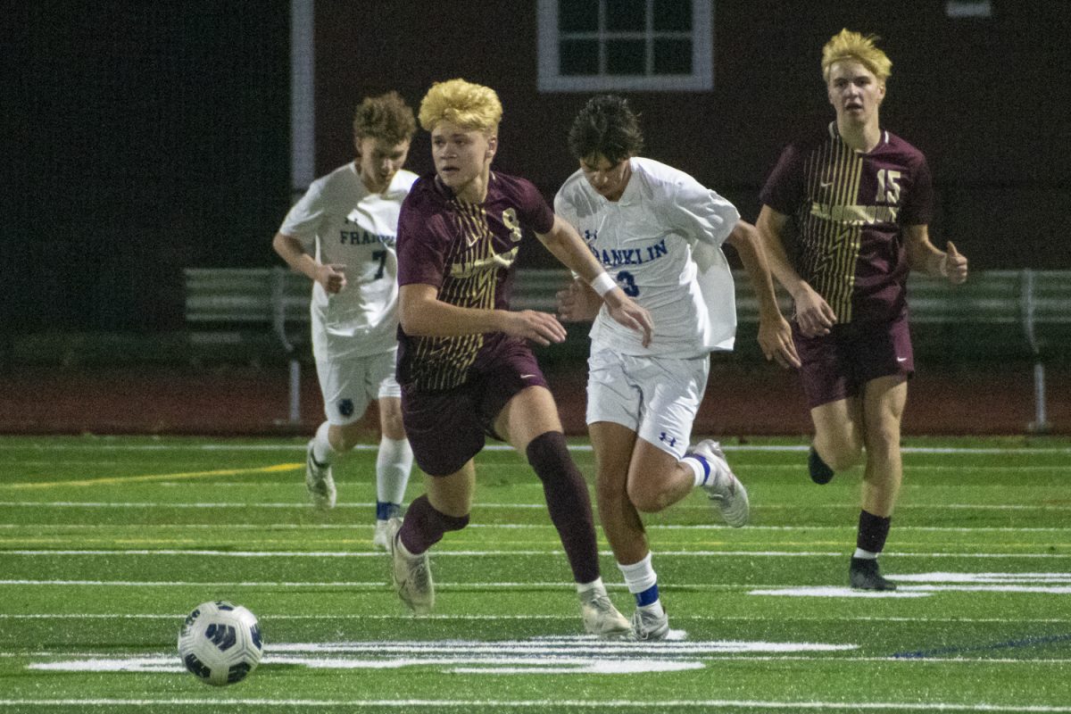 During a 2-1 winning game for Franklin, Algonquin junior Eligio Coniglio (9) and Franklin senior Danny Reis (3) run up the field with the ball on Nov. 5.