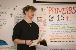 Attending Liberty University Online Academy, senior Josh Vanderwater reads from his Bible during a Bible Club meeting. 