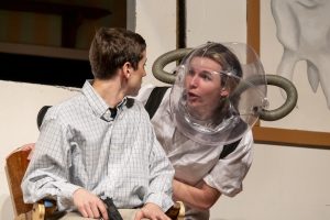 Senior Henry Hart sings "Now (It's Just the Gas)" while sophomore AJ Phaneuf sits in the dentist chair in "Little Shop of Horrors." Hart plays Orin, a sadistic dentist and Audrey's boyfriend.