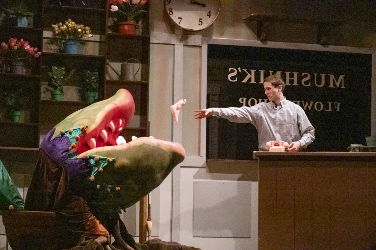 During the first act of "Little Shop of Horrors" sophomore AJ Phaneuf feeds disembodied limbs to Audrey 2, voiced by senior Lydia Reineke.