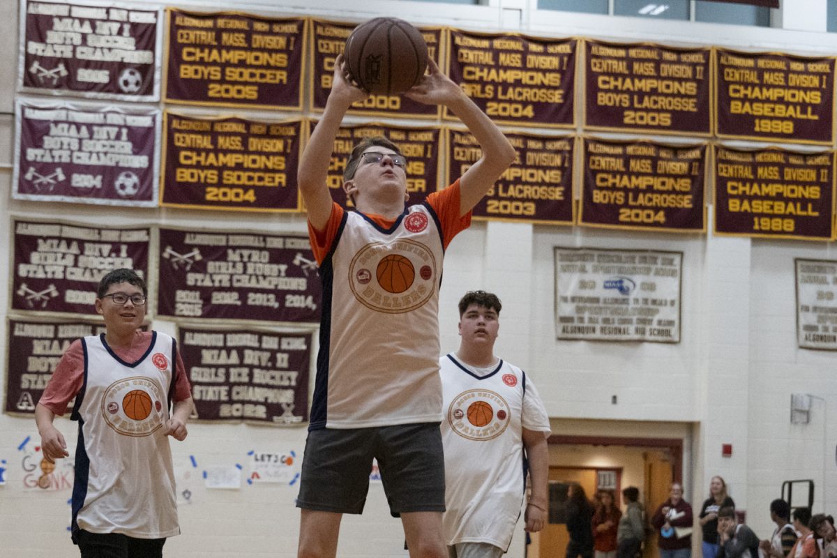 During the "Boros Unified Ballers" game between the Titans Unified Basketball team and the Northborough First Responders, freshman John Campbell shoots the ball.