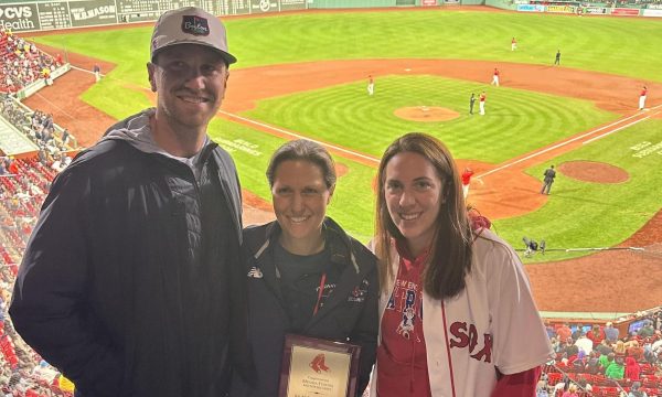 Physical Education teacher Melissa Fustino (center) proudly holds her Red Sox Employee of the Year plaque alongside fellow Physical Education teachers Andrew Kinney and Kristen Morcone.