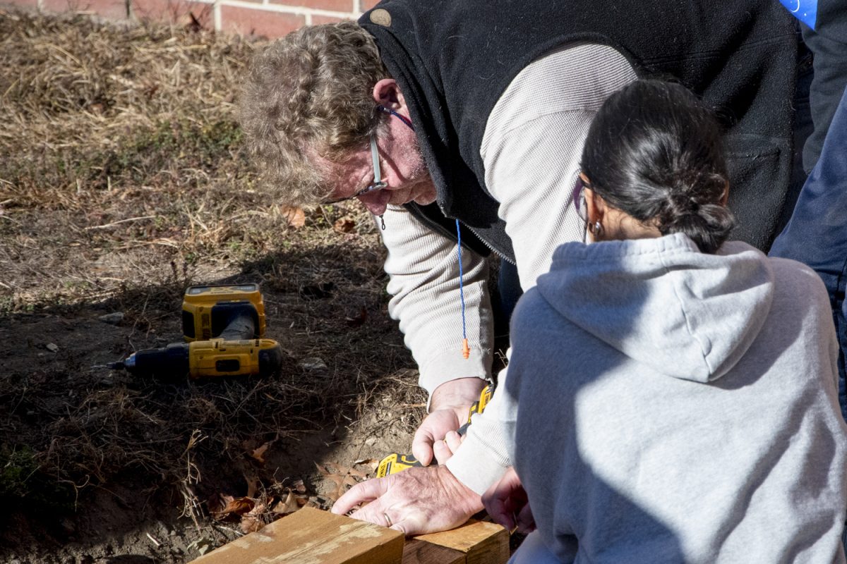 Hands-on Engineering teacher Bruno Nosigilia’s class helps revamp the Tiny Titans playground. “We're using timbers to replace the rotted wood,” Bruno shares as some students help saw the wood down while others work to cut additional pieces.