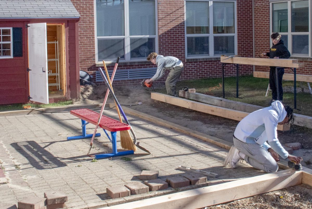 Hands-on Engineering students took various roles in the "Tiny Titans" playground project, from treating new oak as fillers to removing old wood as smashers.  