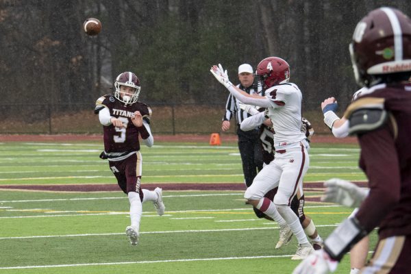 Algonquin senior Will Mahoney (9) throws the ball to his teammate senior Jordan Lopez during the Thanksgiving football game on Nov. 28. The rivalry game between Algonquin and Westborough takes place at the Richard Walsh field, honoring the former coach who passed away this year after over 60 years of dedication to Algonquin.