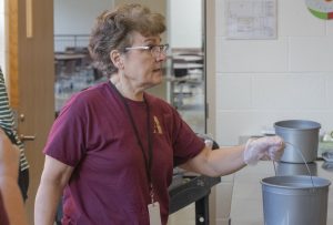 Food Services Manager Dianne Cofer helps clean up the kitchen. Cofer has spent over 20 years serving the Algonquin community in the cafeteria.