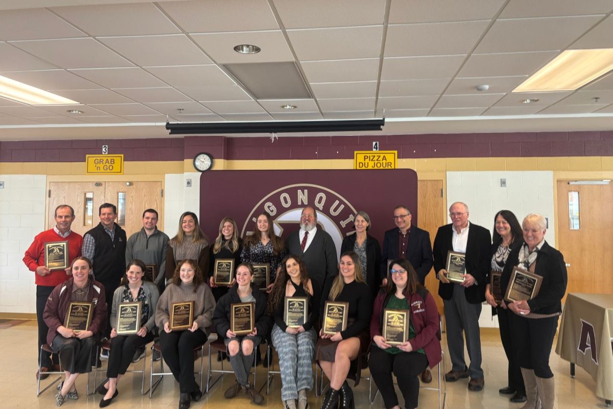 The 2024 Algonquin Hall of Fame inductees pose with their plaques after induction, celebrating their achievements and contributions to Algonquin athletics.