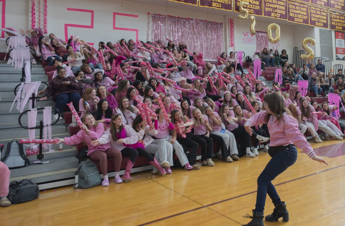The senior class, led by Catie Campbell, does the wave at the 2024 pep rally, hyping up their classmates and getting them in the spirit to compete in more activities.