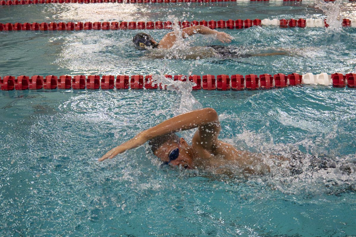 Freshman Osi Mokwunye covers 50 yards, swimming the second leg of the 200m freestyle relay. During the Jan. 2 meet against Shrewsbury, the Algonquin boys' swim and dive team wins 101-72.