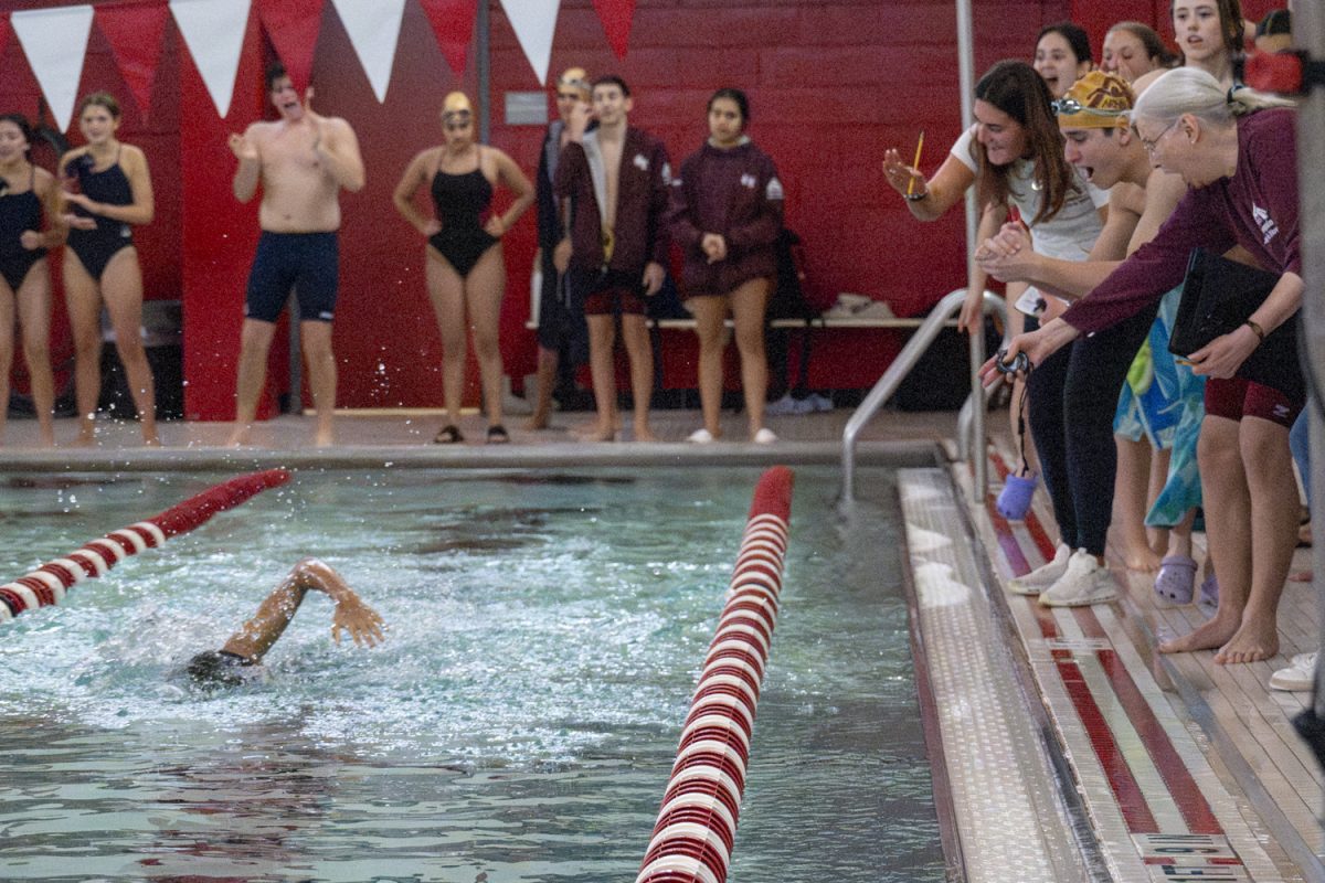 During the ninth event of the Jan. 2 meet against Shrewsbury, freshman Obi Mokwunye swims the third leg of the 200m freestyle relay, swimming 50 yards with his coaches and teammates cheering him on.