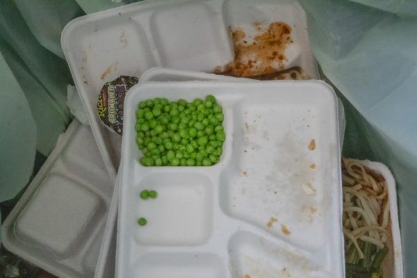 Multiple trays of green peas pile up in the Algonquin compost bin on Jan. 9.