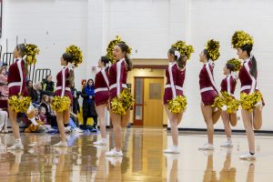 The Algonquin girls cheerleading team cheers during half time of the girls' youth basketball night on Jan. 10.