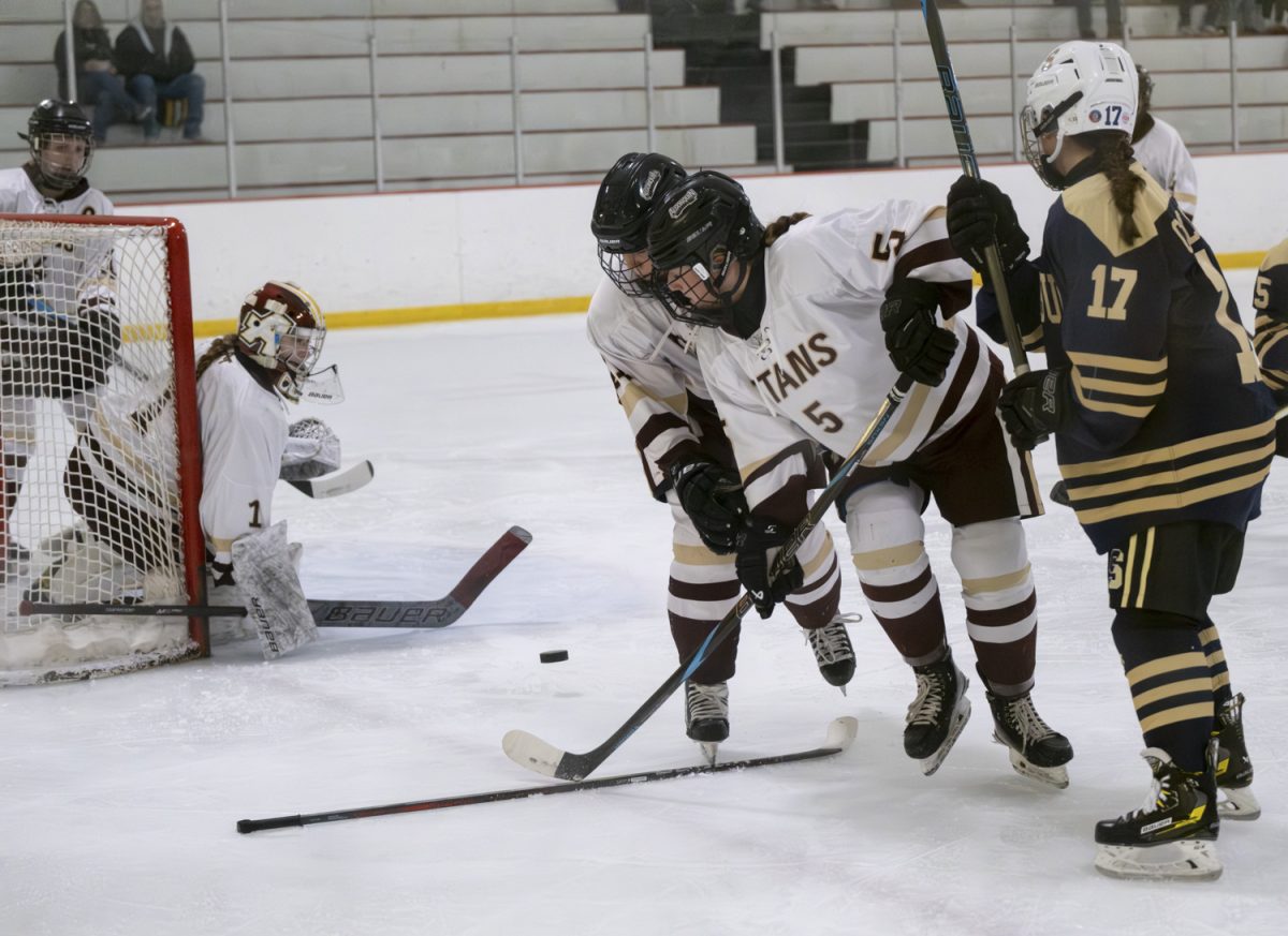 At the girls' hockey game at the New England Sports Center, junior Brenna Joyce defends the goal from the opposing team, Shrewsbury.