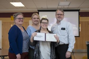 Postgraduate Robin Snow is awarded her certificate, showing her graduation from Algonquin's CAP program. Snow stands with her family, posing for a photo after she receives her diploma.