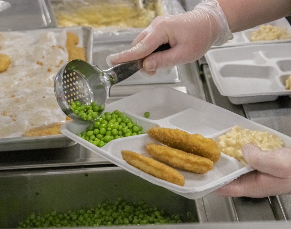 The Algonquin cafeteria staff work very hard to prepare lunches. The staff works to make sure each lunch has an equal serving of chicken tenders, mac and cheese, and peas. As they prepare more trays of food, students are able to grab lunches from the counter.