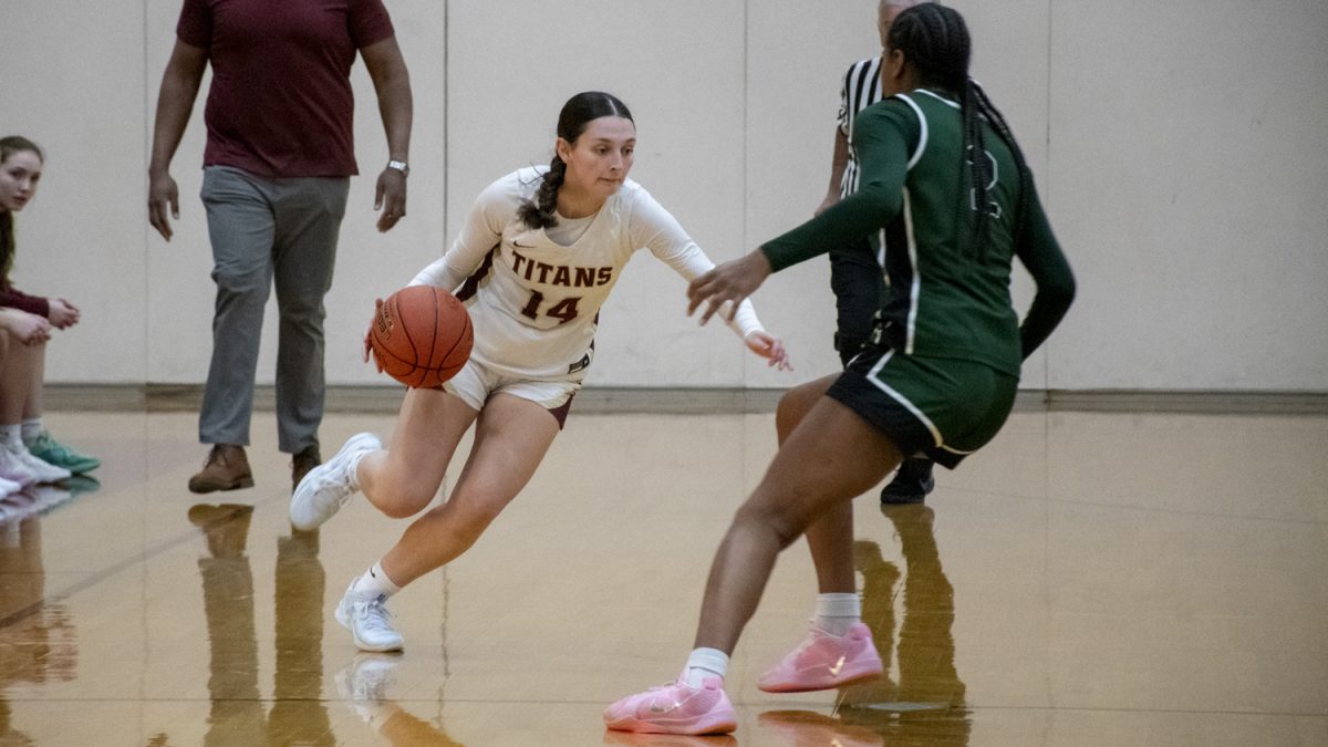 Junior Niki Chacharone dribbles down the court during a 73-42 loss against Wachusett on Jan. 14.