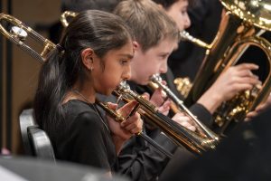 Sixth grader Trisha Mehta plays the trombone during Jazz Night on Feb. 26. Mehta plays for the Trottier jazz band.