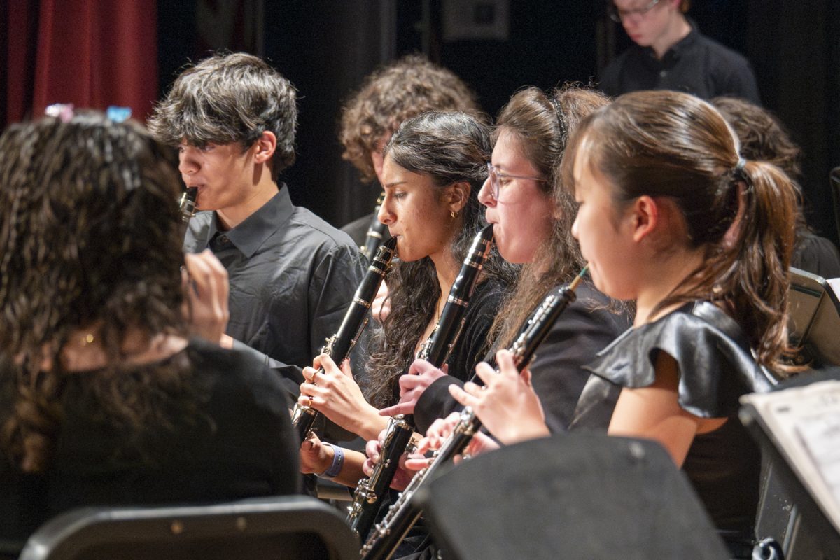 In the clarinet section, freshmen Peter Burrows and Reeth Malrotha, along with sophomore Sabrina Rosa Mesite, perform with the Symphonic Band at the MICCA showcase on April 2.