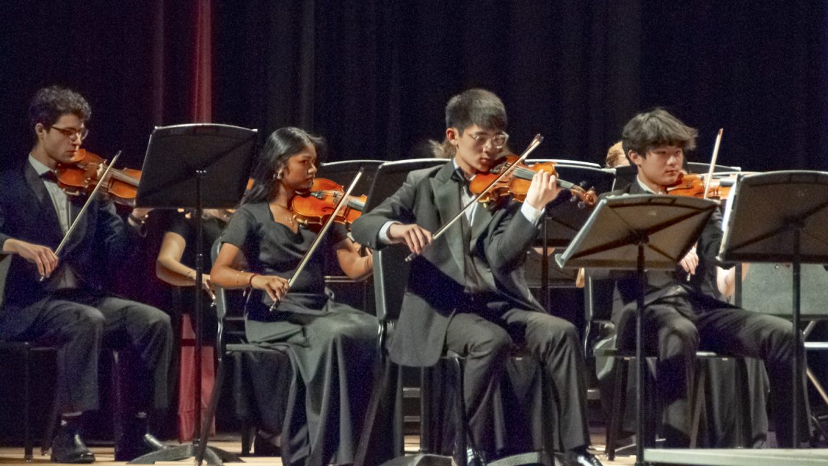 During the MICCA Showcase on April 2, the first violin section in the String Orchestra perform, preparing to play in the festival on April 5.