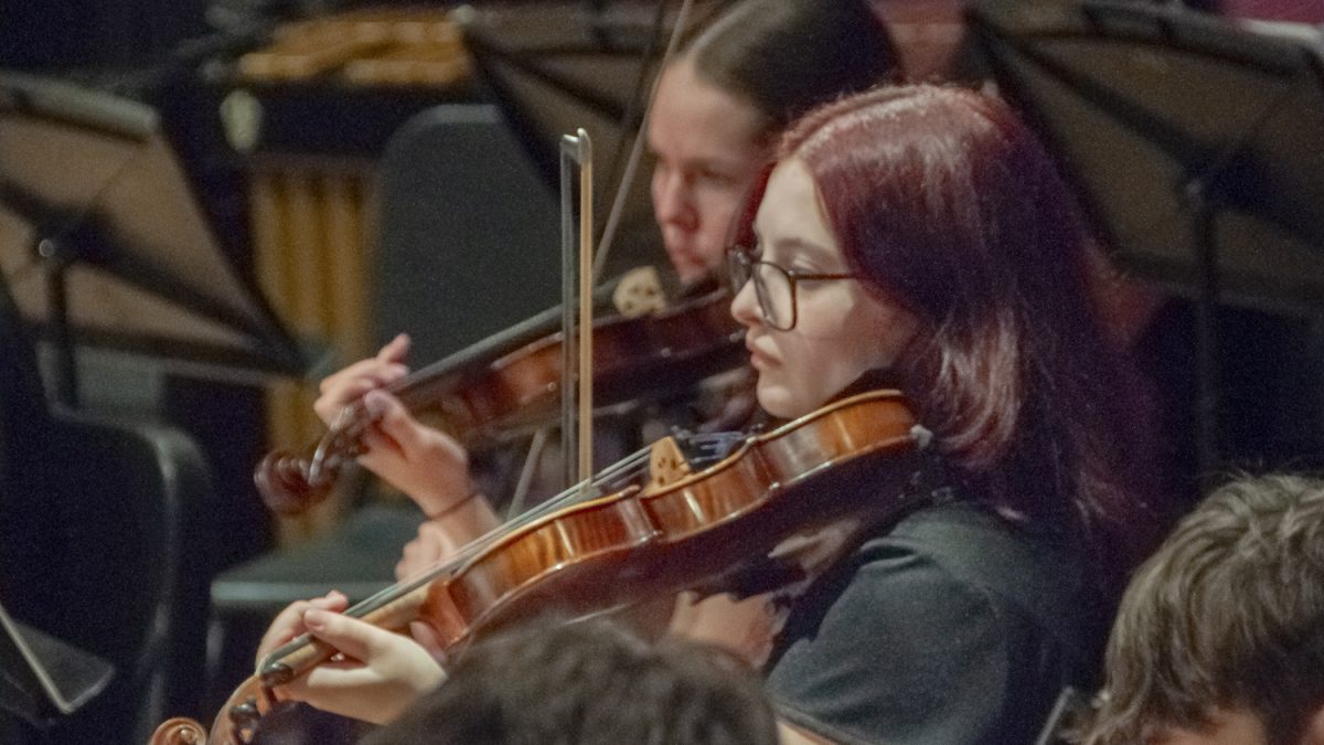 Junior Maddison Wilson performs the violin with the String Orchestra on April 2. During the MICCA showcase, students from the Symphonic Band, String Orchestra and Wind Ensemble performed as they prepared to play in the festival on April 5.