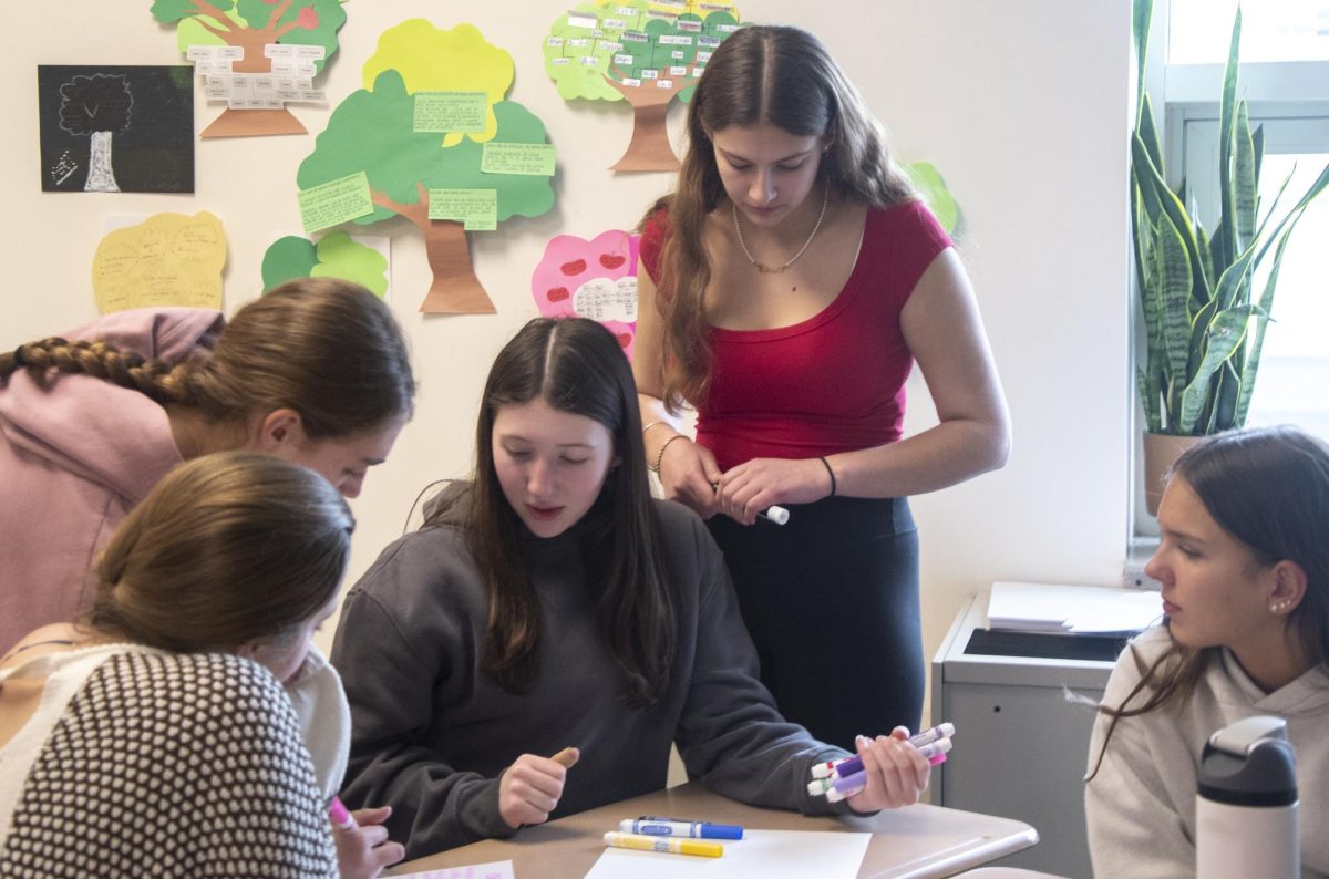 Make-A-Wish Club President junior Gabriella Moore supervises a poster-making activity during a meeting. Moore is a junior at Algonquin who has been co-leading the club since her freshman year. Her sister, Allison, graduated last year, and now she runs the club on her own.
