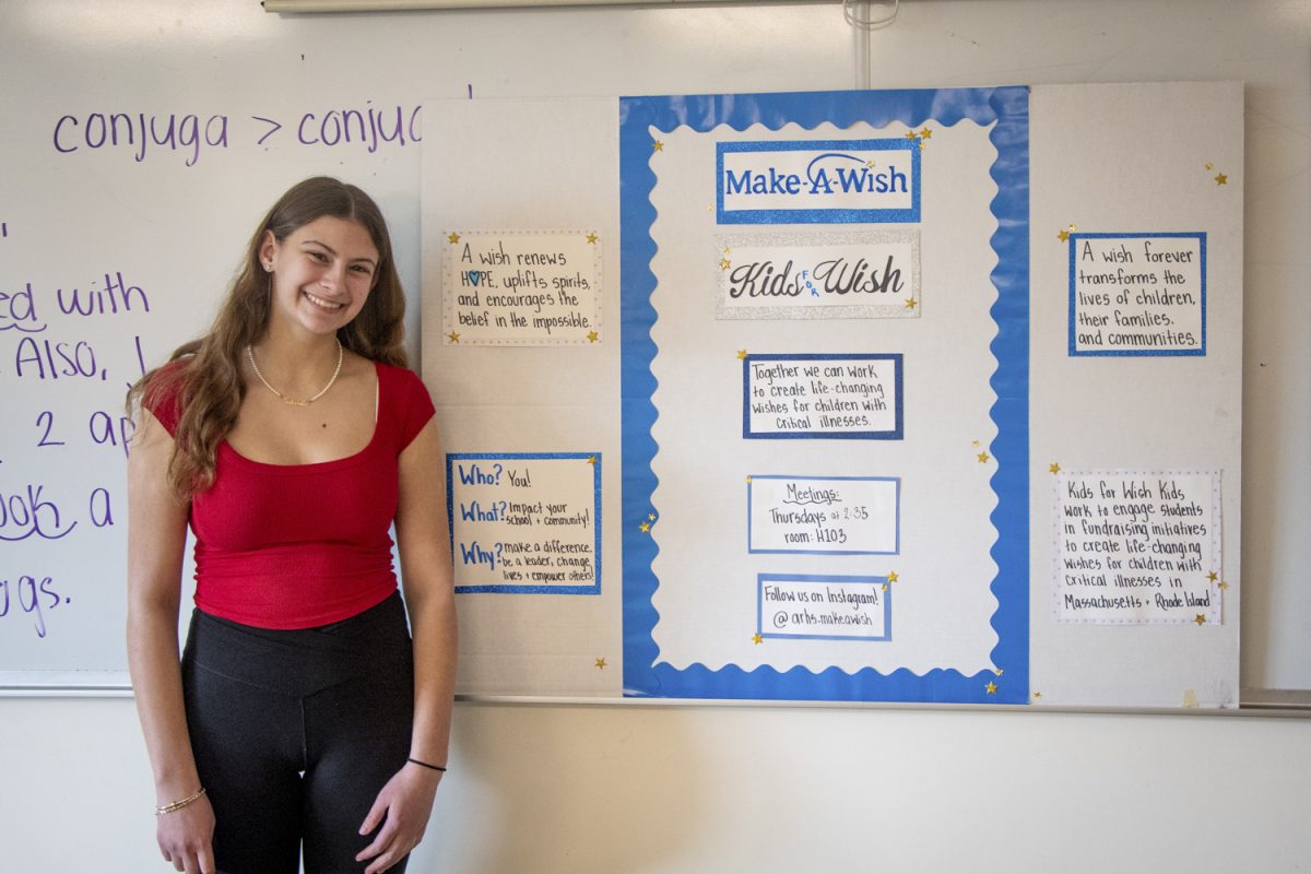 Junior Gabriella Moore displays a poster that advertises the Make-A-Wish Organization’s values at their meeting on April 3. Moore started the club at Algonquin with her sister, Allison Moore, in 2023.