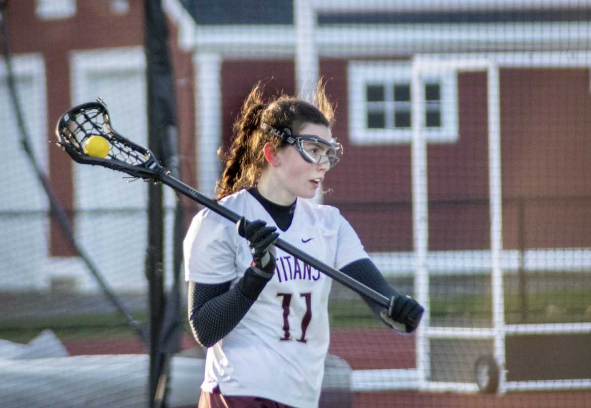 As the offense is settled, junior Rosie Hauck moves around the crease, looking for a pass. The game against Grafton finished with a 16-10 loss for the Titans.