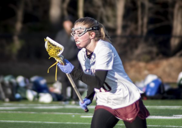 Sophomore Shea Domolky cradles the ball up the field on April 8. The lacrosse game against Grafton resulted in a 16-10 loss for ARHS.
