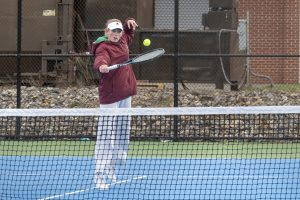 During the girls' tennis game against Westborough, senior captain Emmy Beauchesne jumps up to hit the tennis ball and return it back to her opponent.