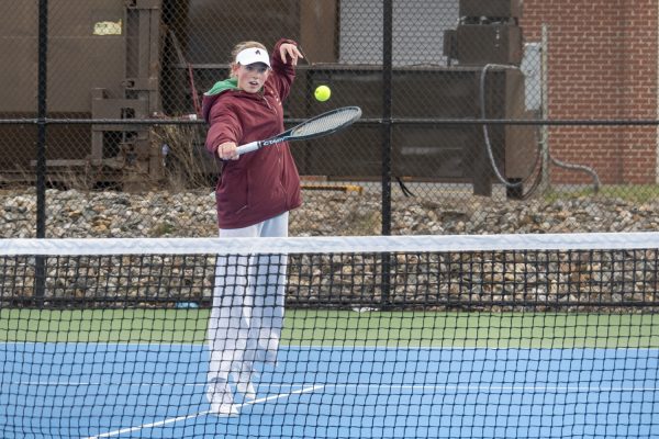 During the girls' tennis game against Westborough, senior captain Emmy Beauchesne jumps up to hit the tennis ball and return it back to her opponent.