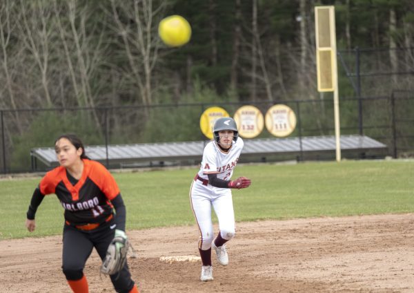 Junior Delaney Walker sprints to third base while keeping her eye on the ball during the girls' softball game on April 11, while playing against Marlborough. Algonquin wins with a final score of 13-6.