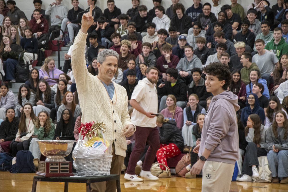 During the second annual rock, paper, scissors championship on April 11, senior Olivia Dornelas loses against Principal Sean Bevan in the end after winning against her classmates. 