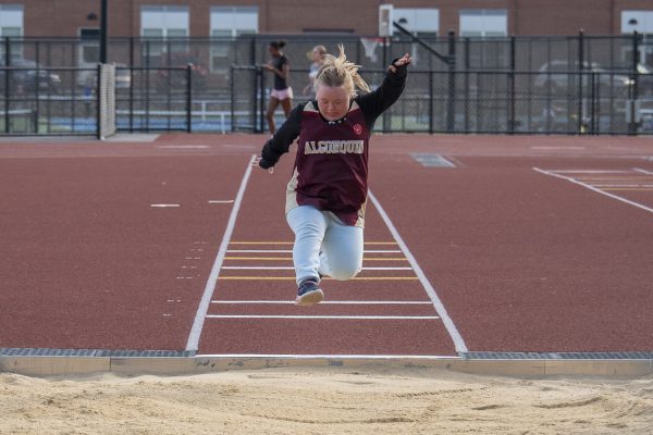 At the Unified Track meet against Shrewsbury, postgraduate Olivia Cheney jumps in the long jump event on April 14.
