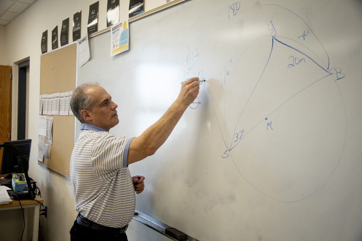 New Algonquin faculty member Robert Sternburg adds an equation to his classroom whiteboard on April 15. Sternburg joined Algonquin this previous winter as a math teacher.