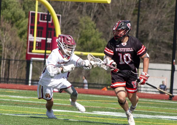Freshman Finn Snyder takes the initiative to attack his opponent in order to steal the ball back for Algonquin during their game against Westfield on April 23. The game resulted in a victory with a final score of 15-5.