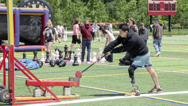 Sophomore Isaac Harrington hits the High Striker Game on May 19. During Carnival there are multiple different games, including Velcro Axe Throw and Mini Golf.