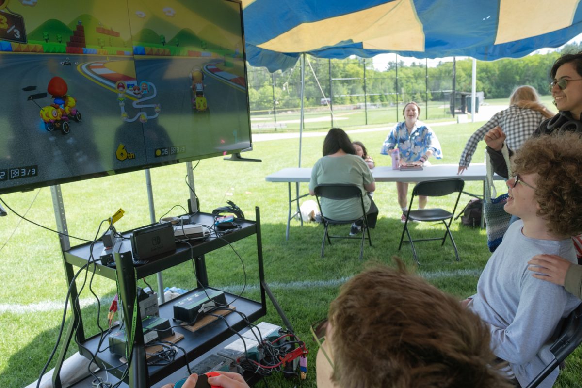 Freshman John Campbell (right)  and freshman Josh Bowman (left) play Mario Kart together with various friends cheering them on in the Robotics tent at Algonquins annual carnival on May 19th.