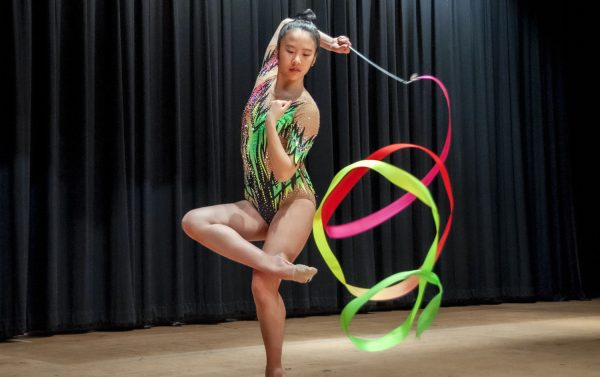 Freshman Amy Zhang creates spirals with her ribbon, one of the apparatuses that rhythmic gymnasts use during a routine. The ribbon is used to perform continuous patterns like spirals, circles and figure-eights. The gymnast must keep the ribbon in constant motion while executing dance and acrobatic elements to create visually appealing shapes, lines and patterns.